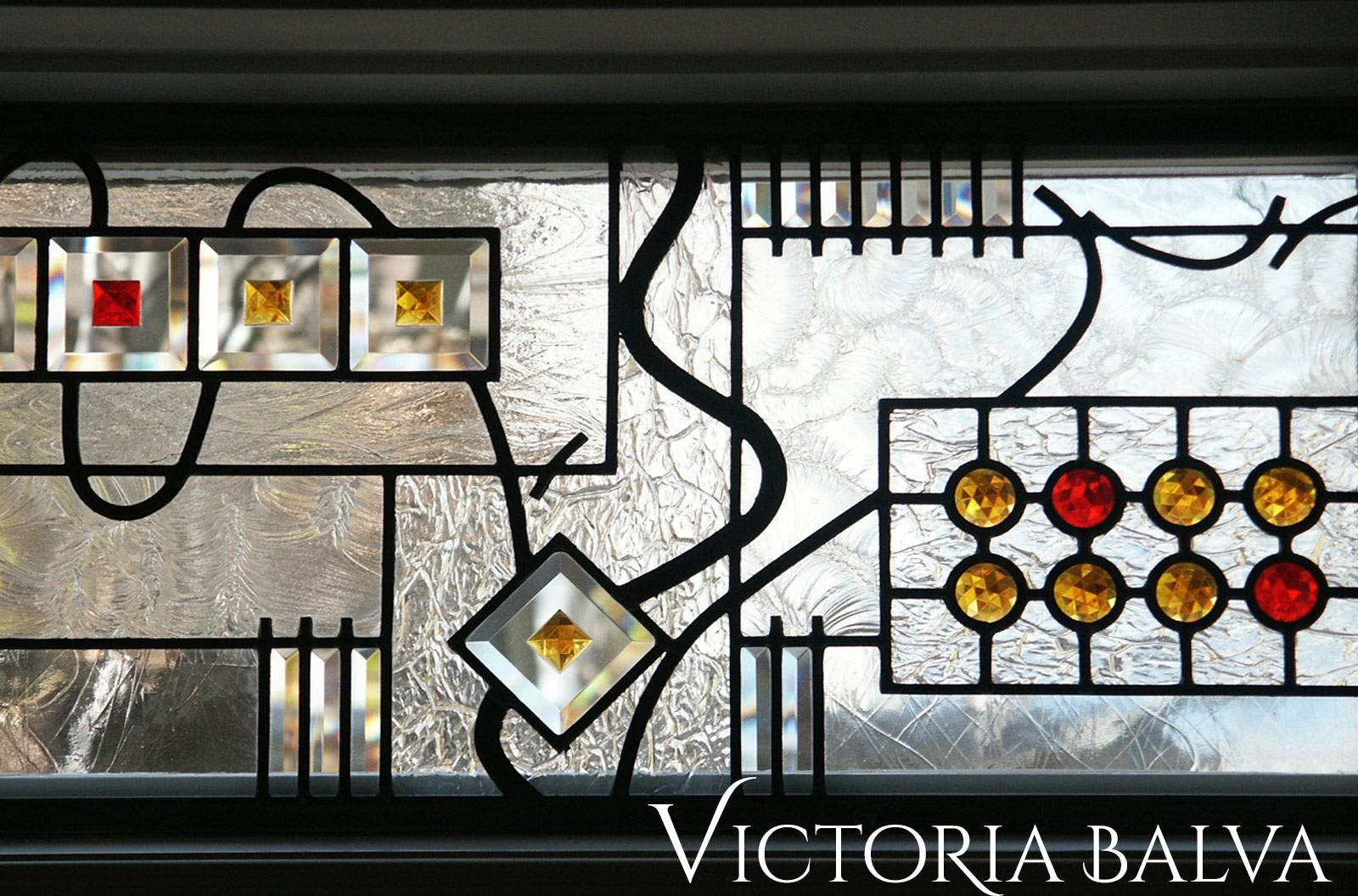 Stained and leaded glass transom windows with jewels and bevelled glass for family room