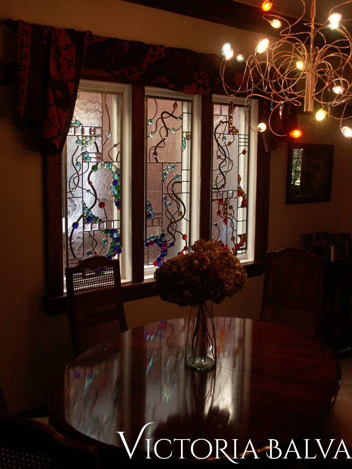 Stained and leaded glass free shape suspended panels with nuggets and bevelled glass after installation