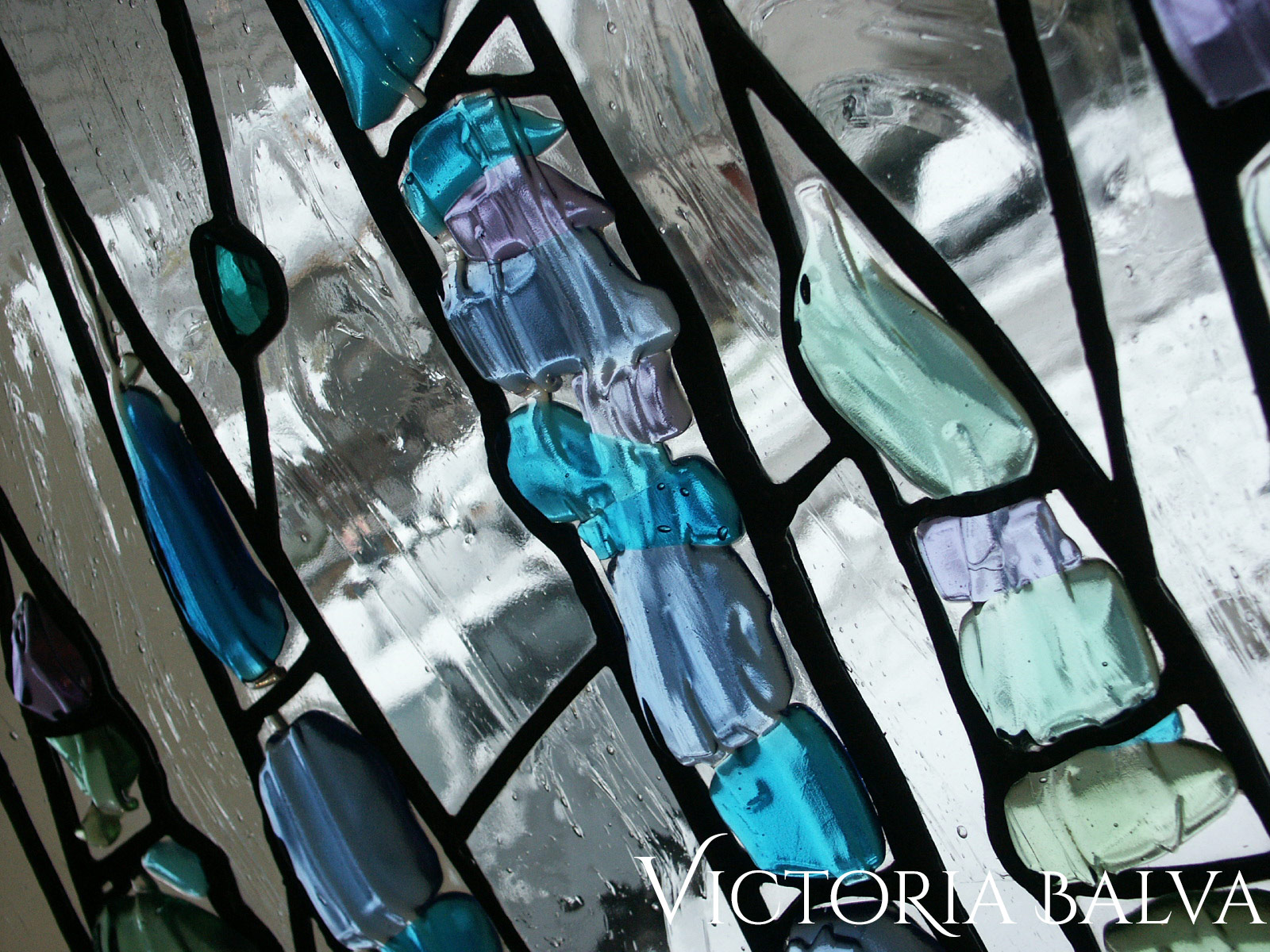 Contemporary stained, fused and leaded glass sculpture for the foyer window of a private residence in blue colors