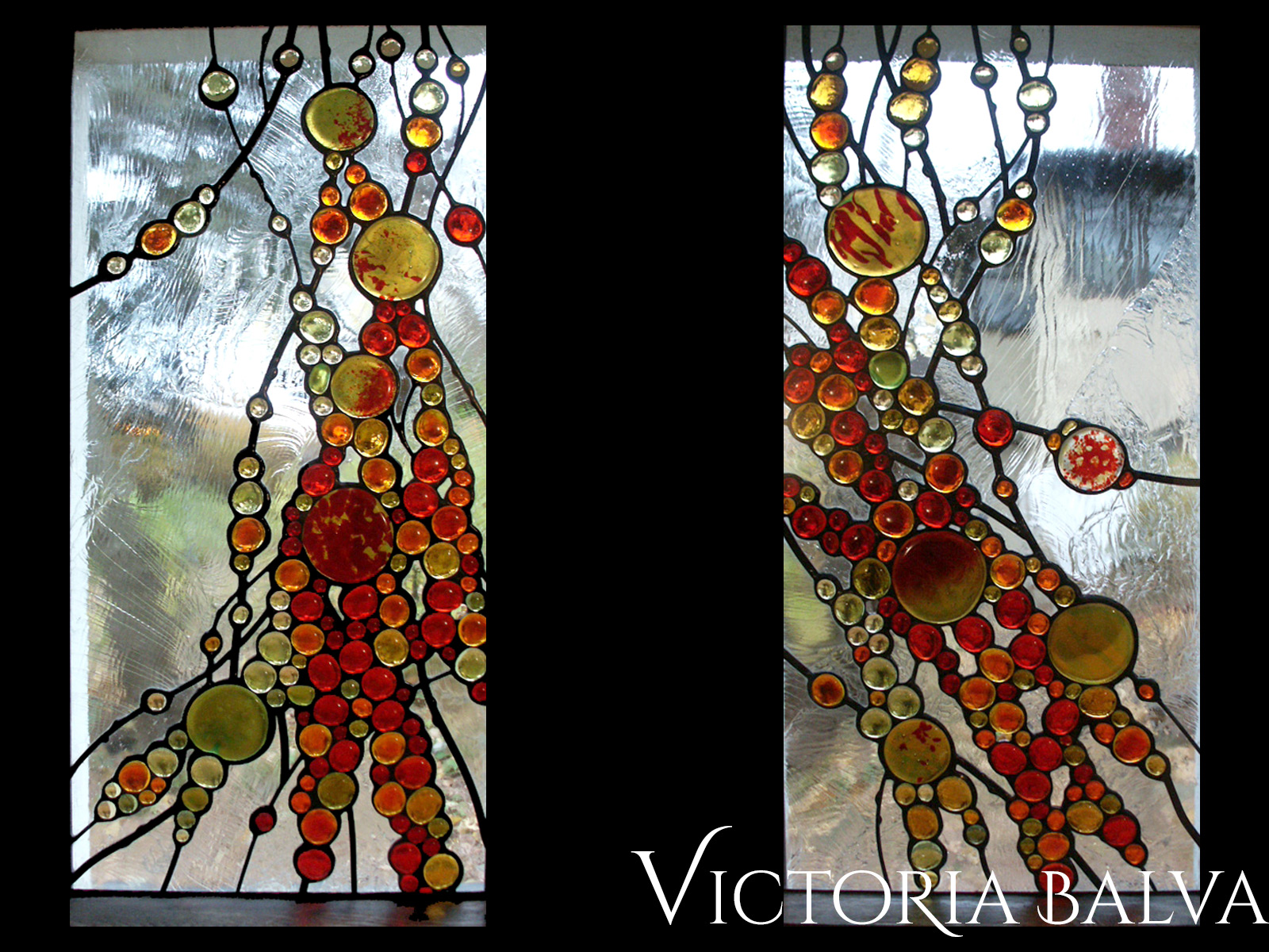 Abstract stained, fused and leaded glass windows for the family room with fireplace in red and amber tones