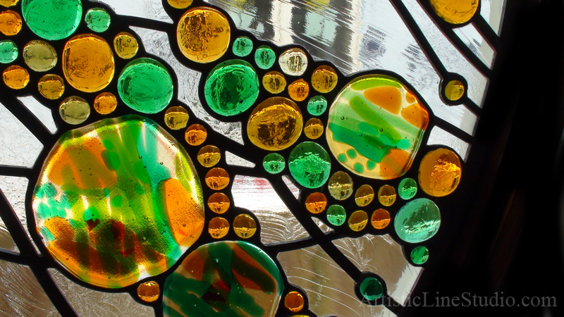 Contemporary stained and leaded oval window with kiln formed elements