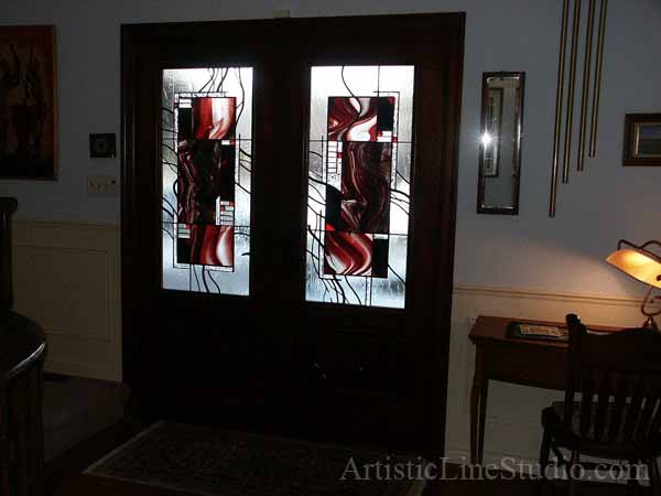 Stained and leaded glass door lights of custom made mahogany door with hand carving