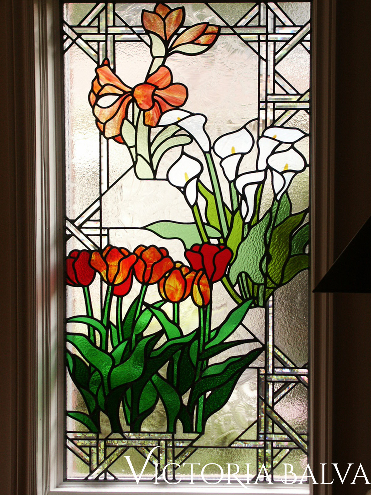Stained leaded glass window. Flower garden. Amoralis, Tulips, Lilias. Overall view of the window